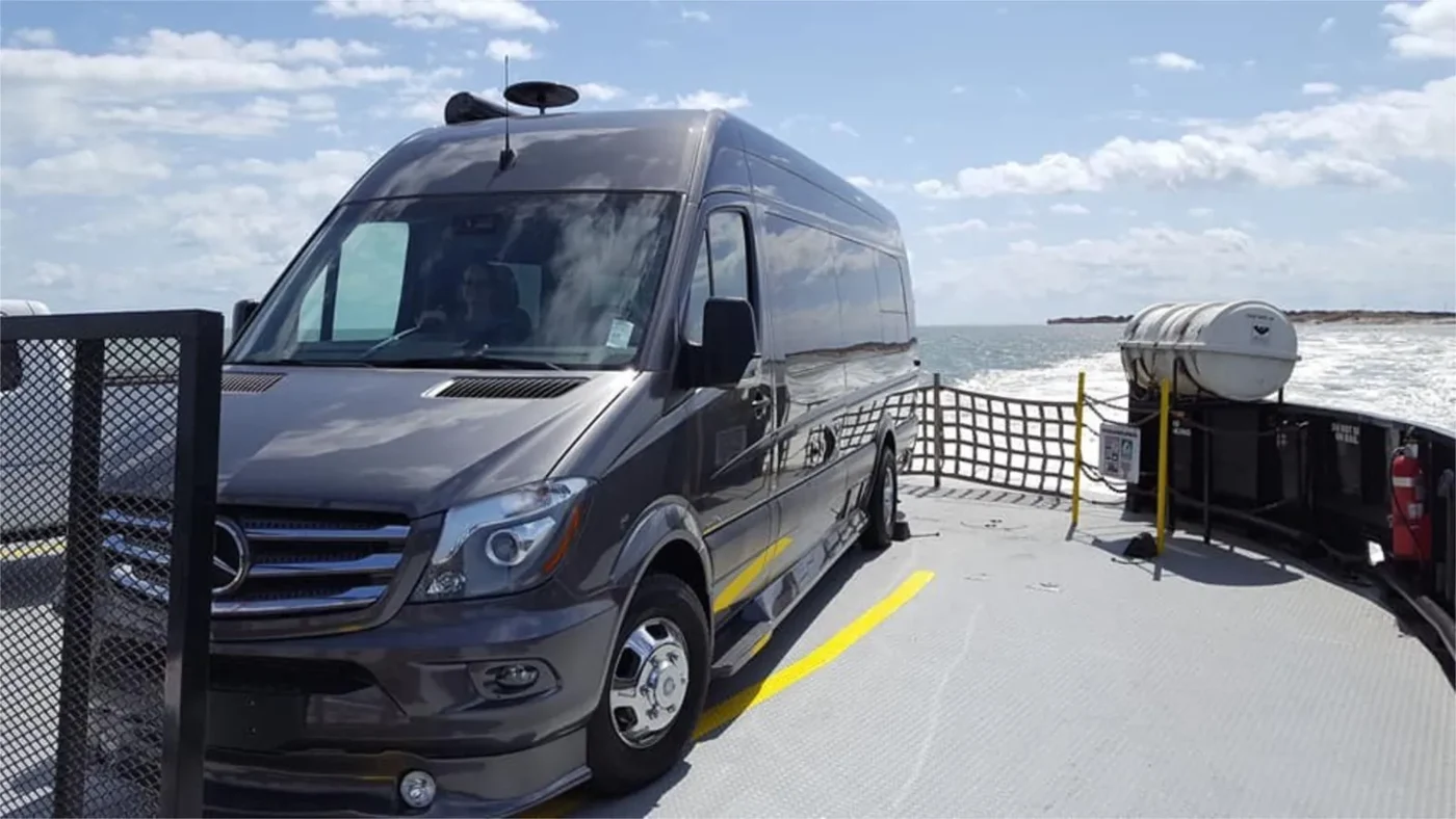 Black Mercedes Sprinter conversion parked on a ferry deck
