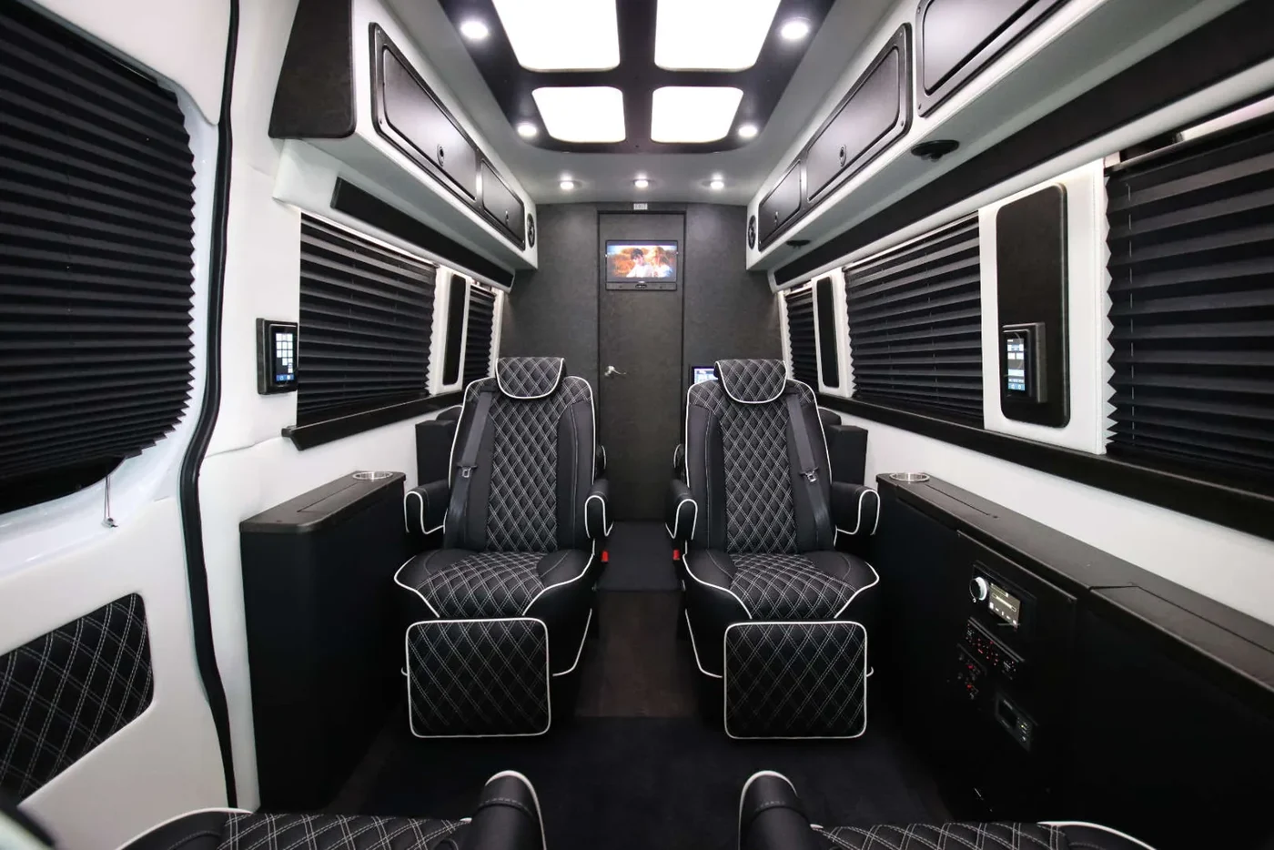 Luxury Sprinter cabin with a large display and passenger seating